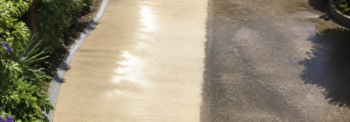 Concrete driveway before and after pressure cleaning